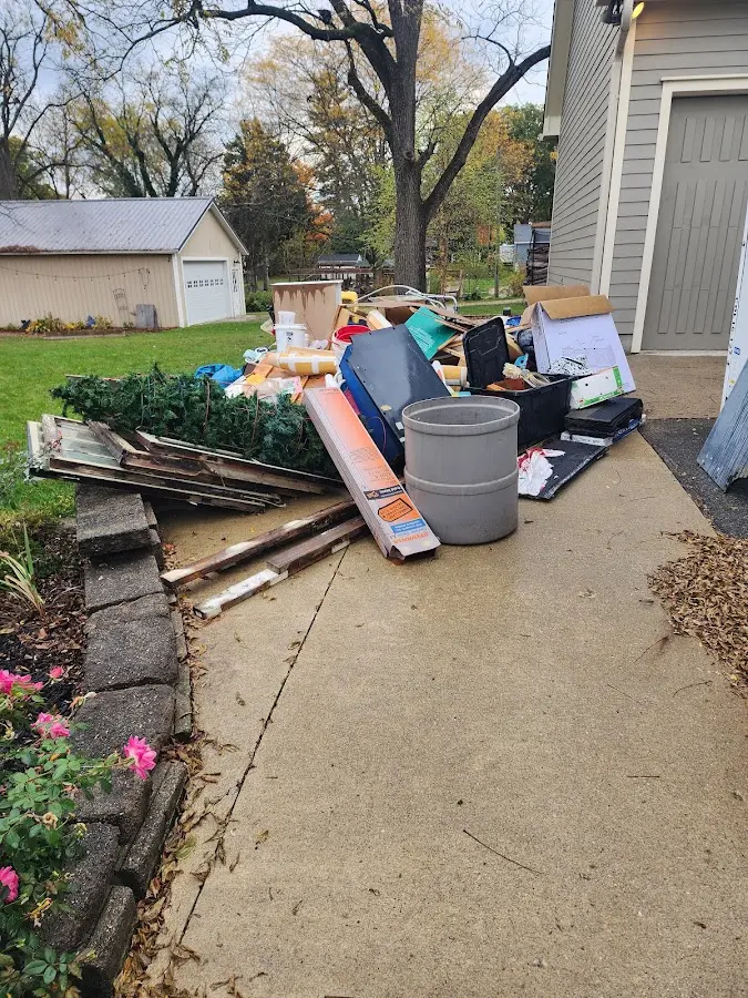 Dumpster being loaded with debris for 10 Yard Dumpster Rental in Woodlawn Beach